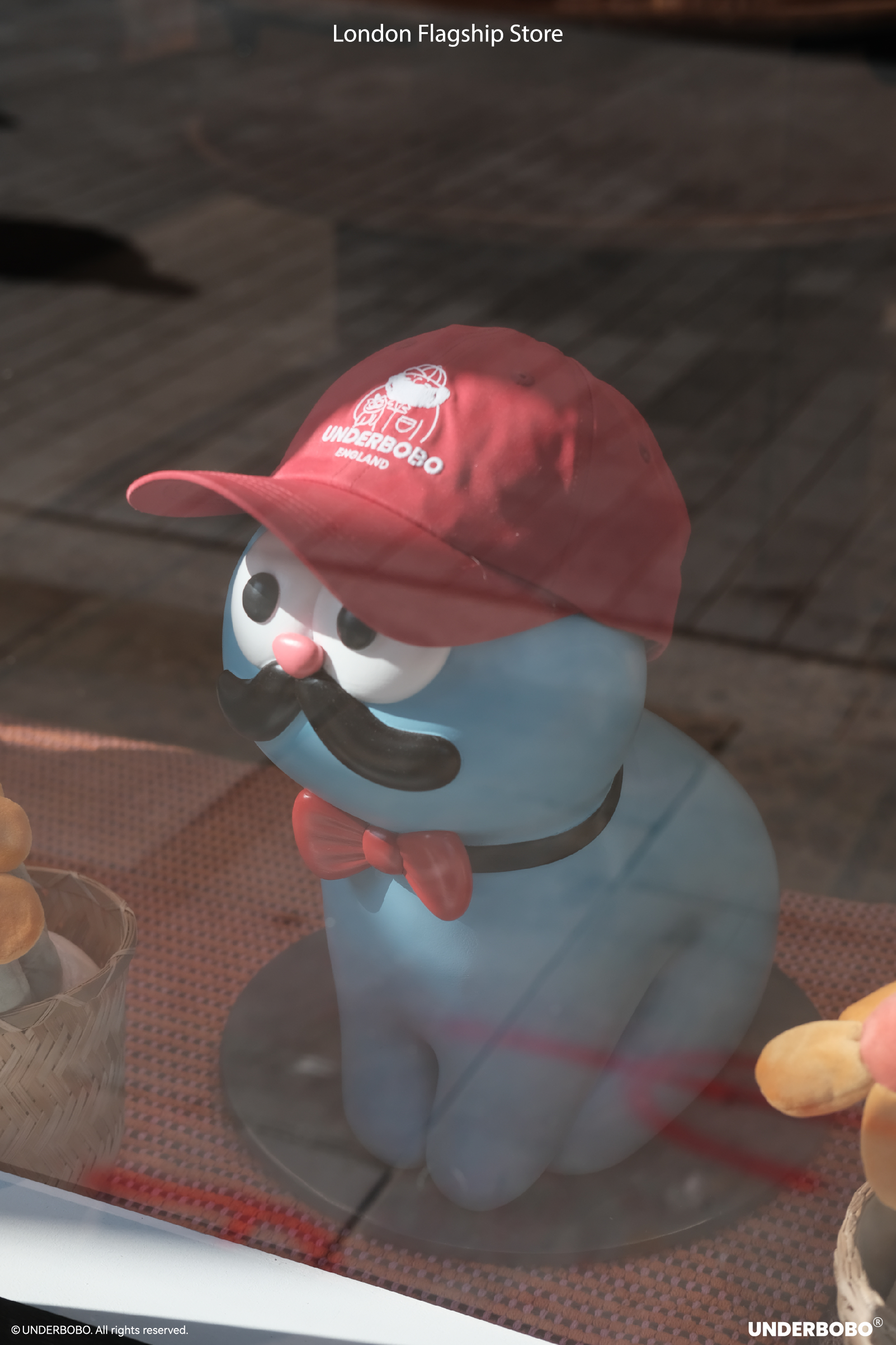 UNDERBOBO figure behind glass